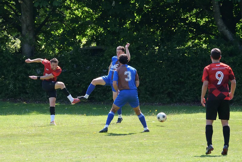 Polegate Town Football Club match in progress, players kicking the ball